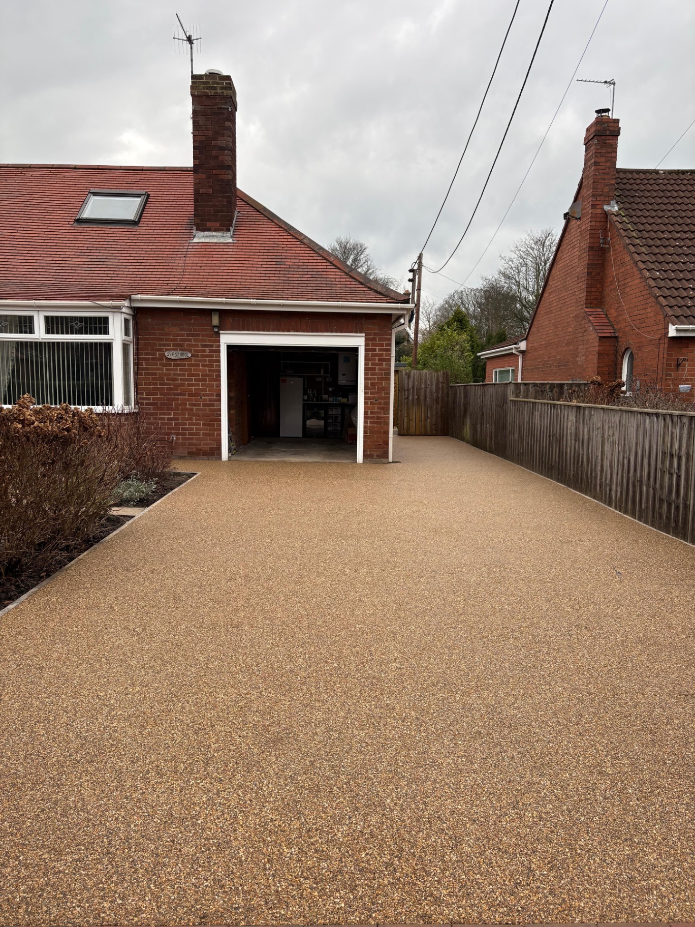 Golden resin bound driveway finished to a garage frontage